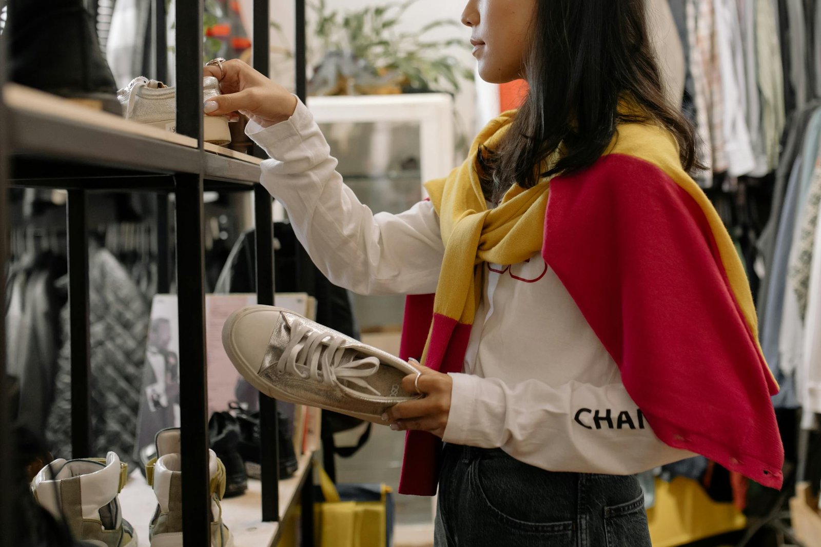 A woman browsing sneakers in a thrift store, showcasing the retail shopping experience.